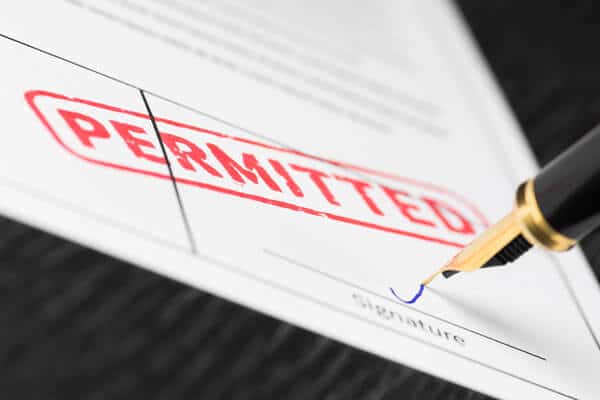 Closeup of permit being signed