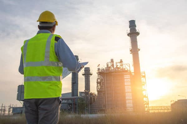 Engineer standing outside a power plant
