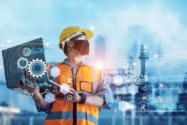 An engineer analyzes a power plant holding a laptop with graphics overlaid on top